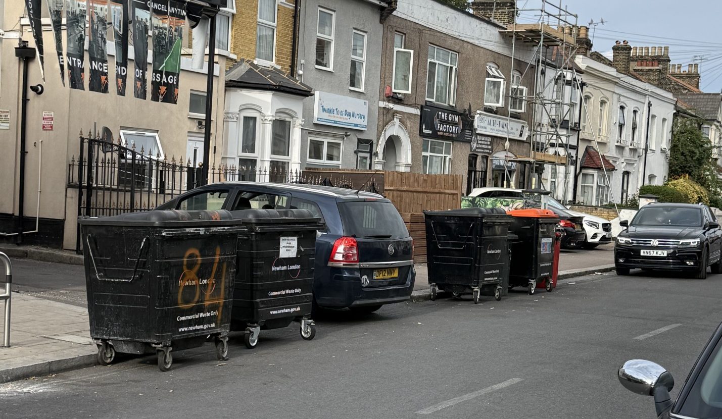 Sebert Road, with several commercial bins placed on the road.