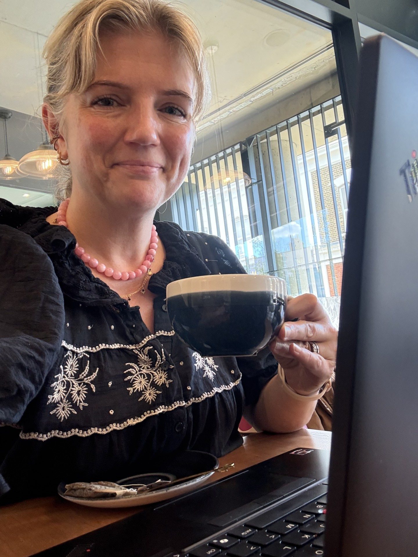 Rachel and her laptop, and a cup of coffee